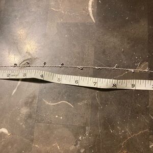 10” sterling silver anklet with teardrop shaped amethyst cubic zirconia drops.